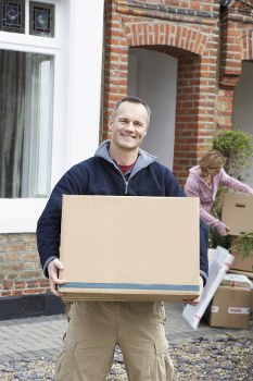 Removal van and moving boxes near riverside homes in Wapping