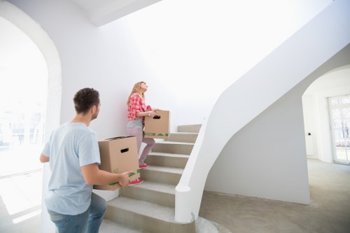 Packed moving boxes and furniture ready for transport in a Wapping property