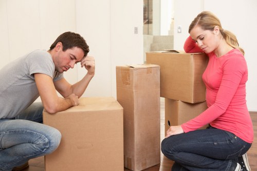 Professional movers handling furniture in a Wapping apartment building