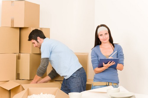 Local movers carrying boxes through a Wapping apartment building